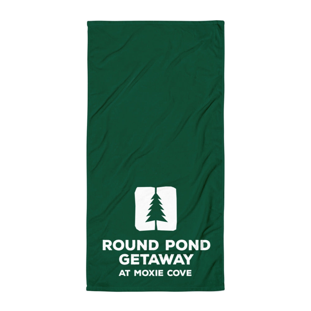 Green towel with the round pond getaway logo printed in white