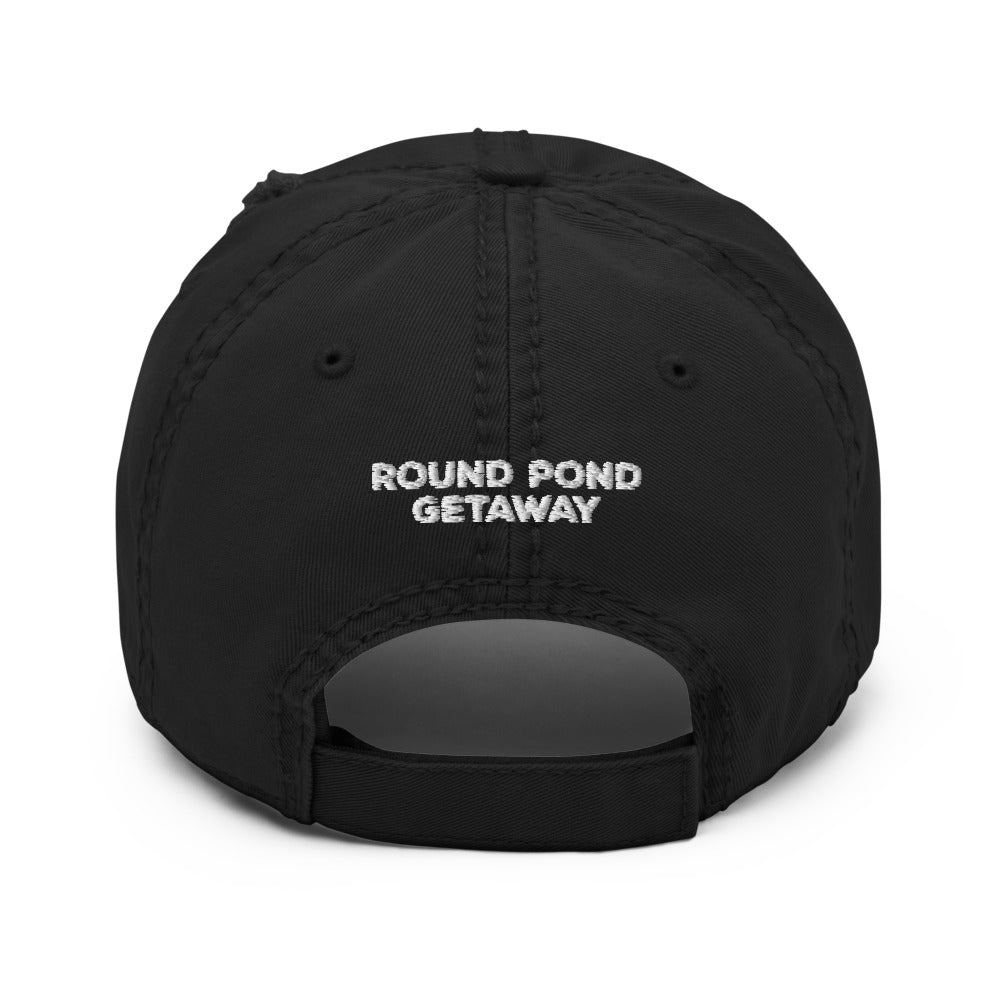 black distressed baseball hat with round pond getaway word logo embroidered in white.