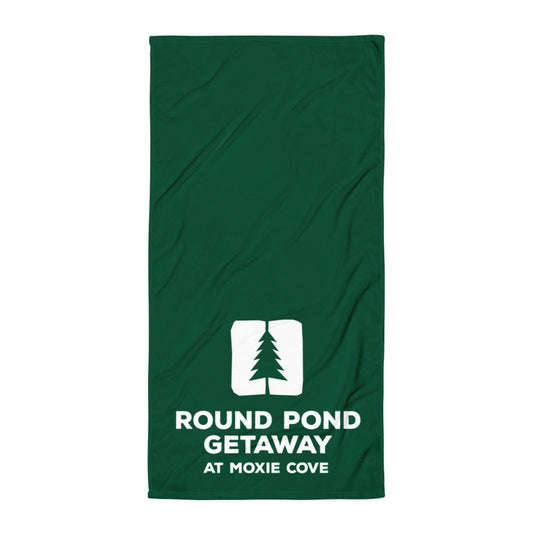 Green towel with the round pond getaway logo printed in white